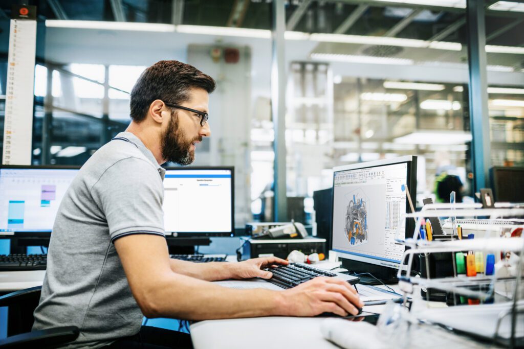 Man in factory working at a computer