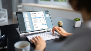 The Rise of E-Invoicing - man typing on computer