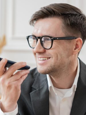 a man holding a phone to use Dragon Anywhere Mobile