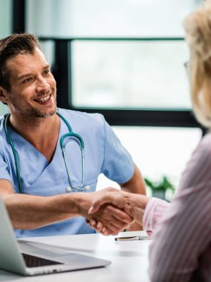 1434 doctor shaking the hands of a patient after completing a consultation using Corti