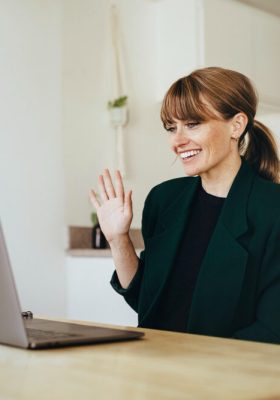 a woman having a call using her laptop