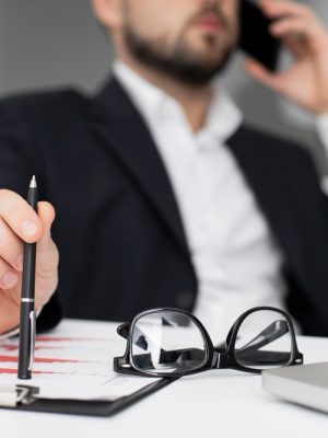 2148738335 Picture of a lawyer holding a pen and a paper while being on the phone
