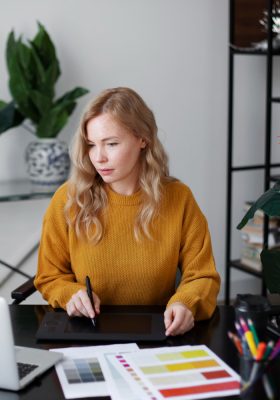 a woman sitting at a desk using a tablet to edit document using Ysoft SafeQ