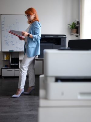 a woman standing in front of a whiteboard