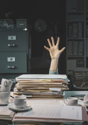 Desperate office worker overwhelmed with paperwork, she is asking help with her hand