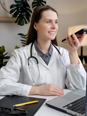 a woman in a white coat holding a phone