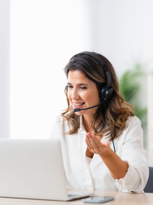 a woman wearing a headset behind a computer