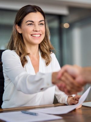 a woman shaking hands with a man