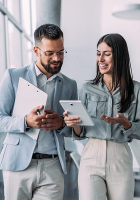 a man and woman looking at tablet