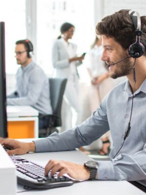 a man wearing a headset and using a computer with Grundig GoSpeech