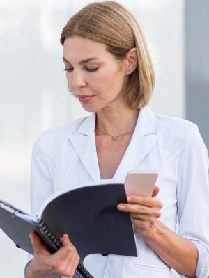 a woman holding a notebook and a phone