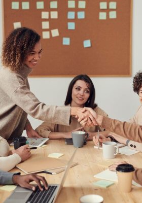 People in a meeting, 2 persons are giving a hand shake