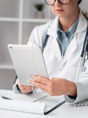 portrait-doctor-video-conferencing-clinic_23-2148728383 a doctor in a white coat using a tablet with DAX Copilot