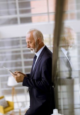 Portrait of senior businessman using digital tablet in the office