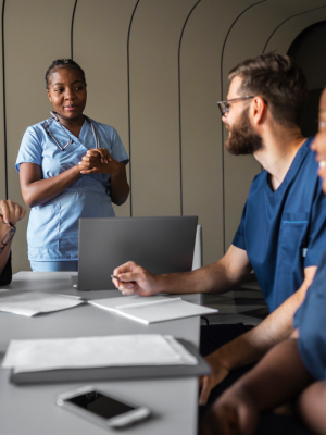 a group of people in scrubs talking to a nurse