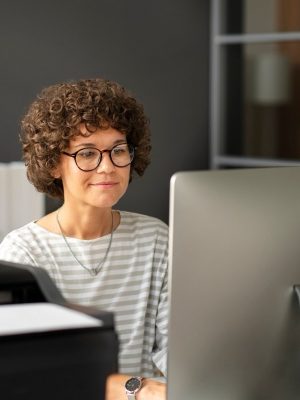 a woman looking at a computer screen