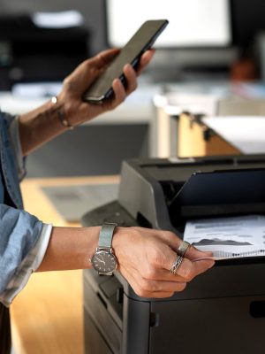 Employee holding smartphone. Scanning a document using Tungsten VRS Elite