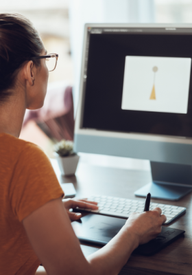 young-female-designer-working-computer-her-home-studio 1